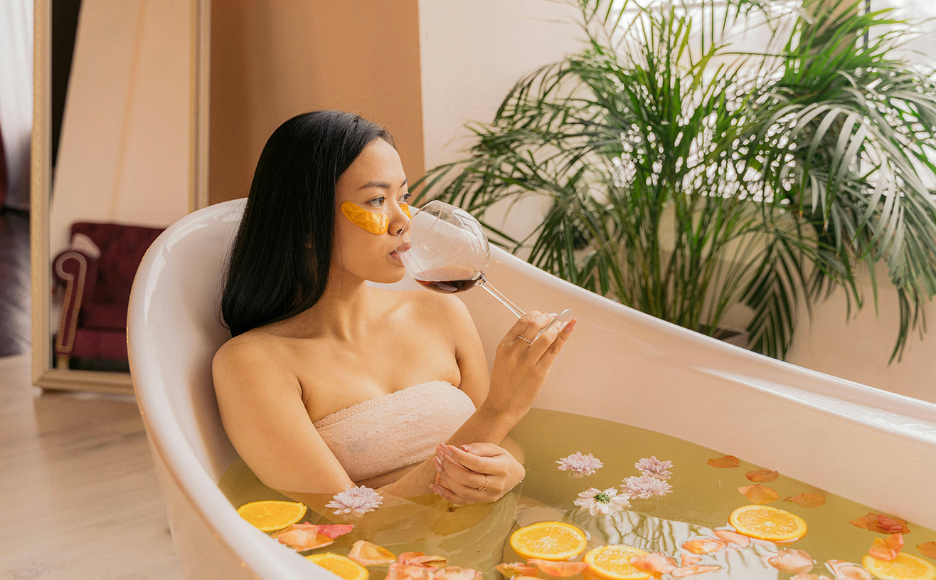 Woman enjoying a luxurious herbal floral bath ritual